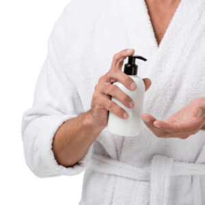 cropped-image-of-man-in-bathrobe-using-body-lotion-2023-04-04-16-54-09-utc