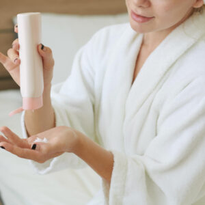 woman-applying-nourishing-body-lotion-2022-01-28-05-13-30-utc
